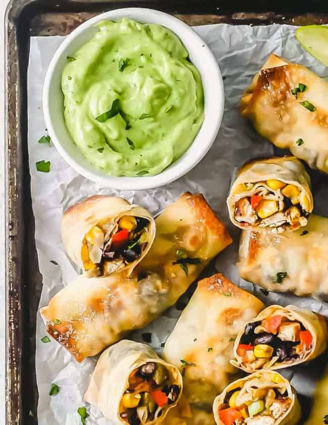 Baked Southwest Chicken Egg Rolls are packed with seasoned chicken and veggies, then baked until crispy and golden brown. Southwest Egg Rolls are served with an avocado dipping sauce, which is easy and perfect! This Baked Egg Rolls Recipes makes an outstanding appetizer to feed a crowd or a healthy after school snack!