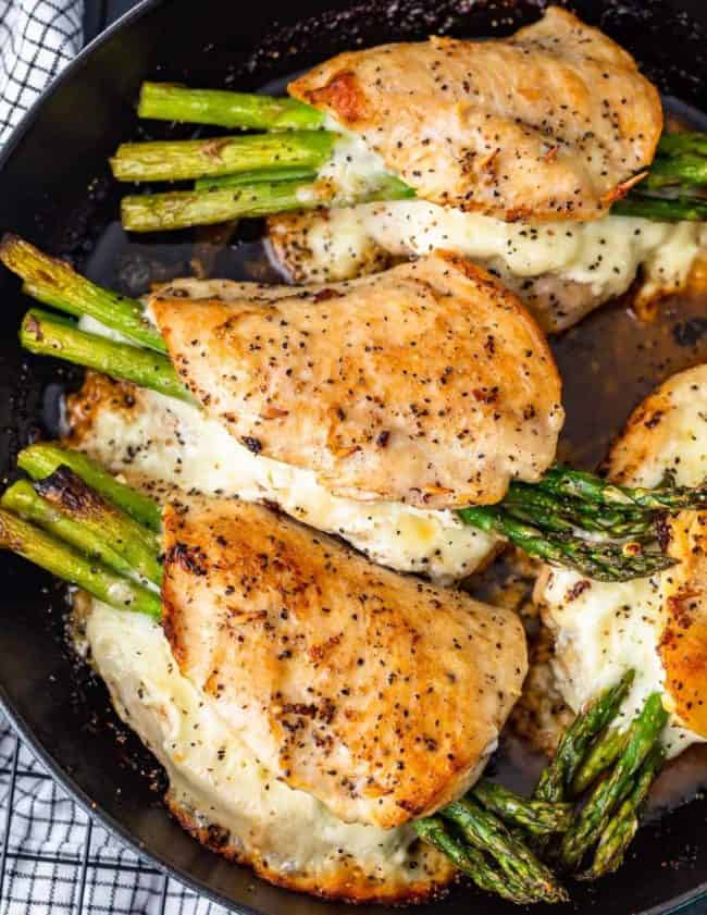 Cheesy Asparagus Stuffed Chicken Breast is the BEST Stuffed Chicken Recipe we have ever made! Tender chicken loaded with two types of cheese (goat cheese and mozzarella) and asparagus just can't be beat. The flavor is out of this world! Chicken and Asparagus for the win.