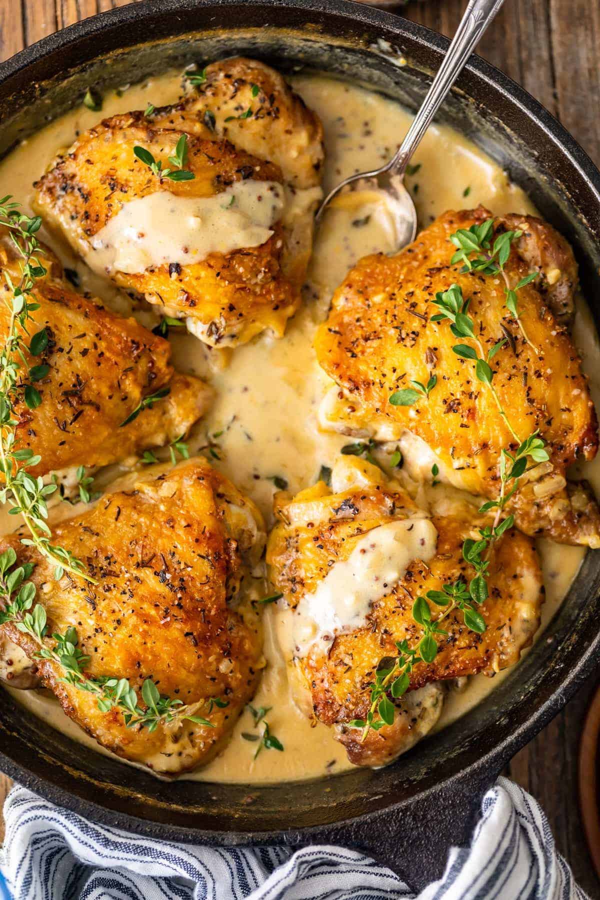overhead view of chicken in white wine sauce in a skillet