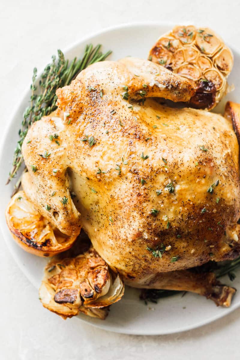 roast chicken with garlic and lemon on plate