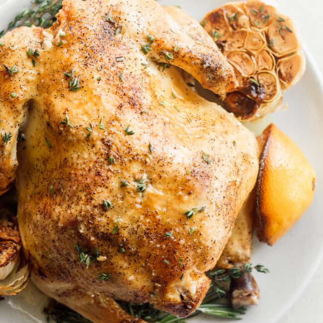 roast chicken with garlic and lemon on plate