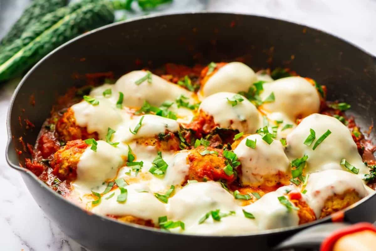 baked chicken meatballs with cheese in skillet