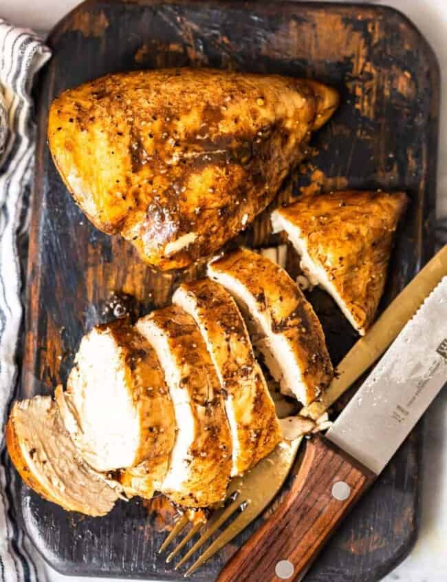 baked lemon pepper chicken on cutting board