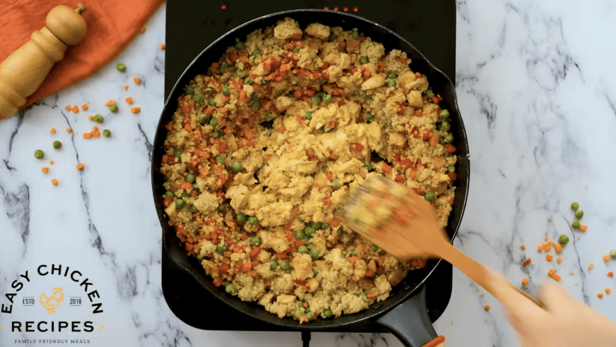 Eggs are scrambling in the middle of the skillet. 