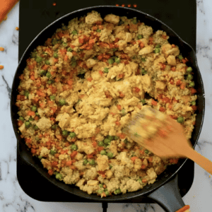 Eggs are scrambling in the middle of the skillet.