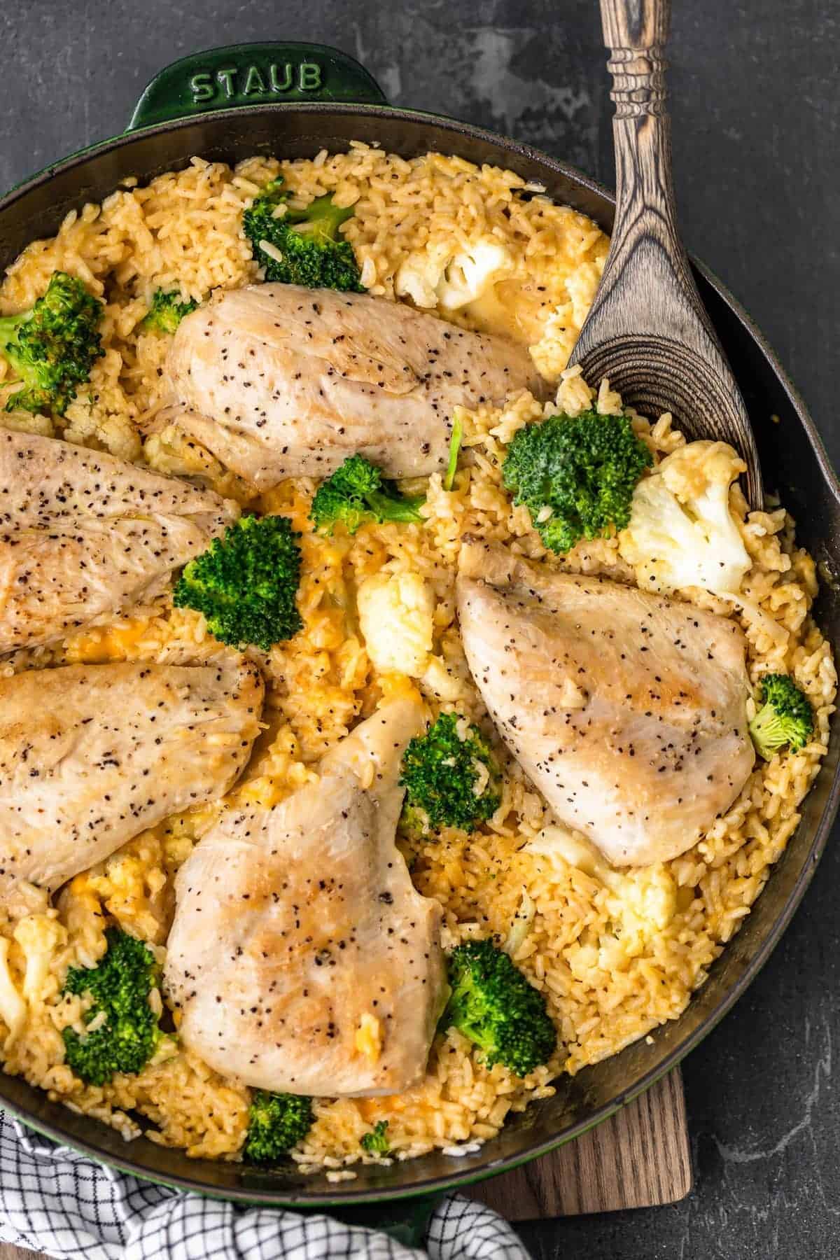One Pot Cheesy Chicken and Rice with broccoli and cauliflower in skillet