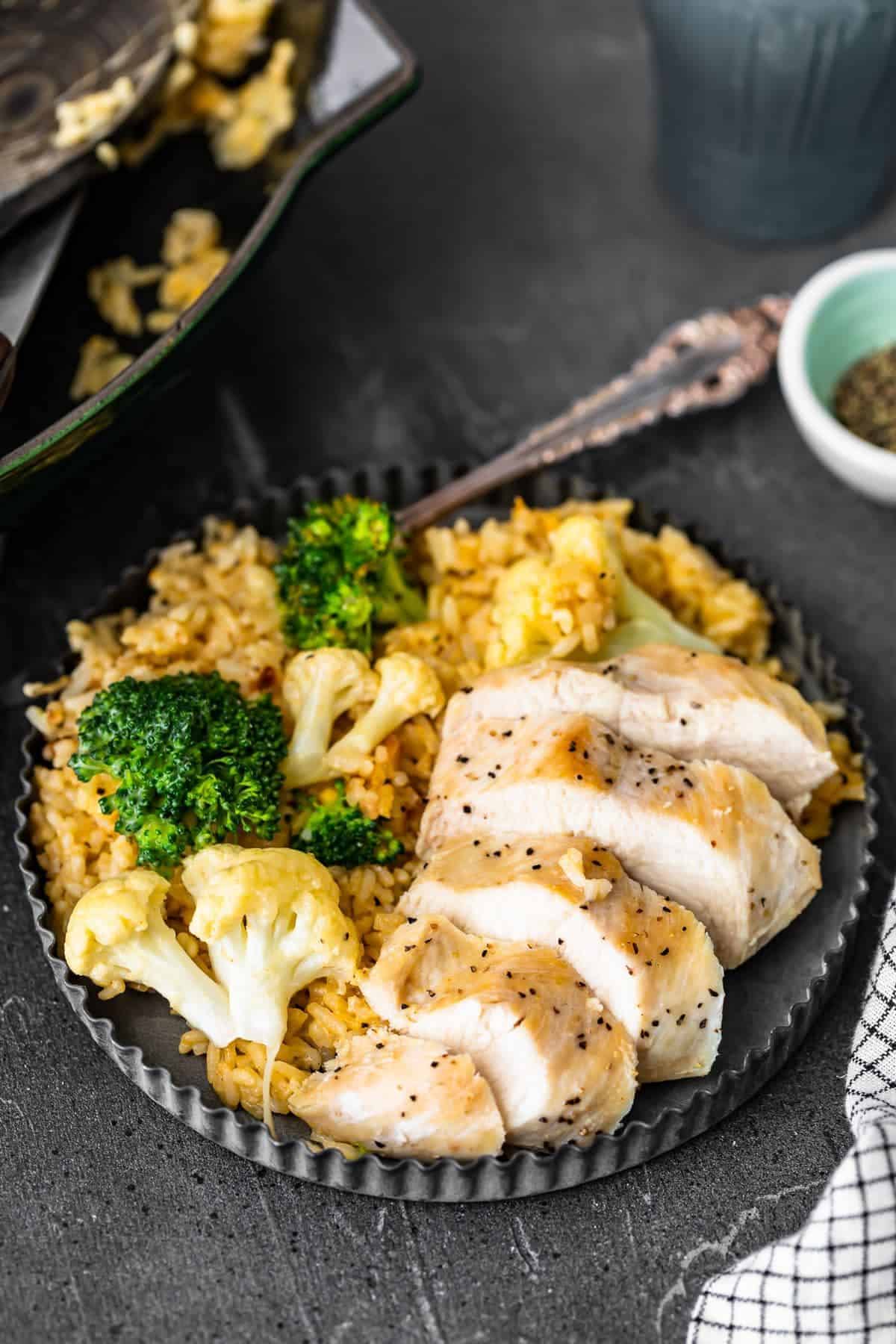 Cheesy Chicken and Rice with broccoli and cauliflower sliced chicken