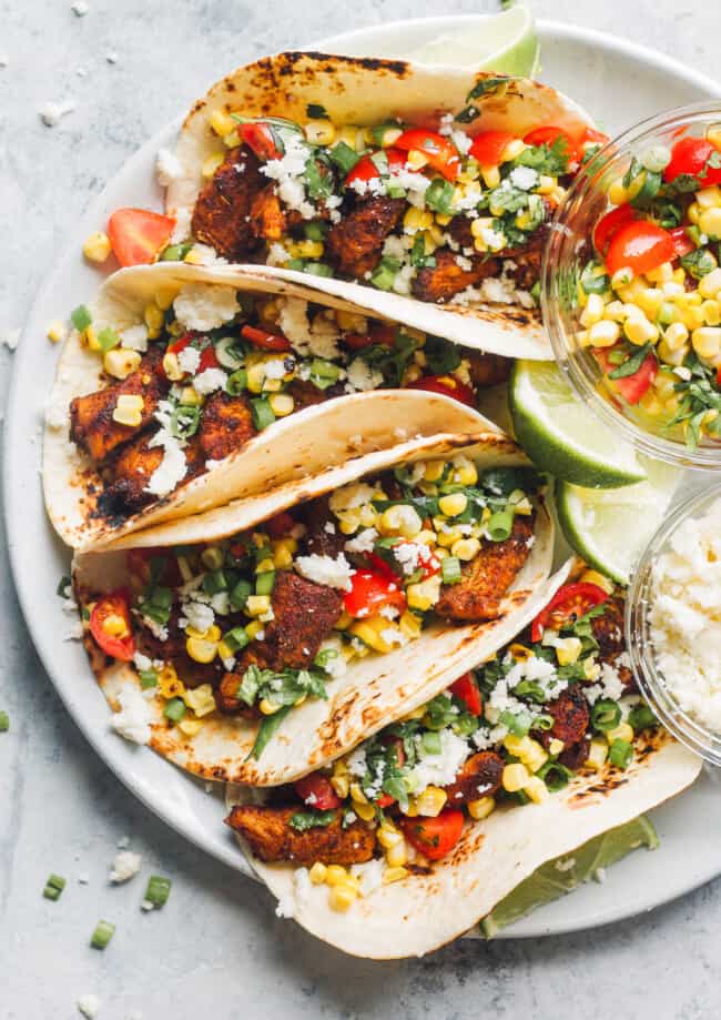 marinated chicken tacos on plate with corn salsa