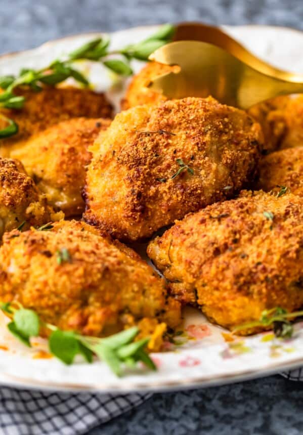 Oven Fried Parmesan Crusted Chicken Breast is a family favorite, making comfort food easy and healthier! This Baked Parmesan Chicken tastes fried but is actually our favorite baked chicken breast recipe!