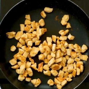 cooked cubed chicken in a pan.