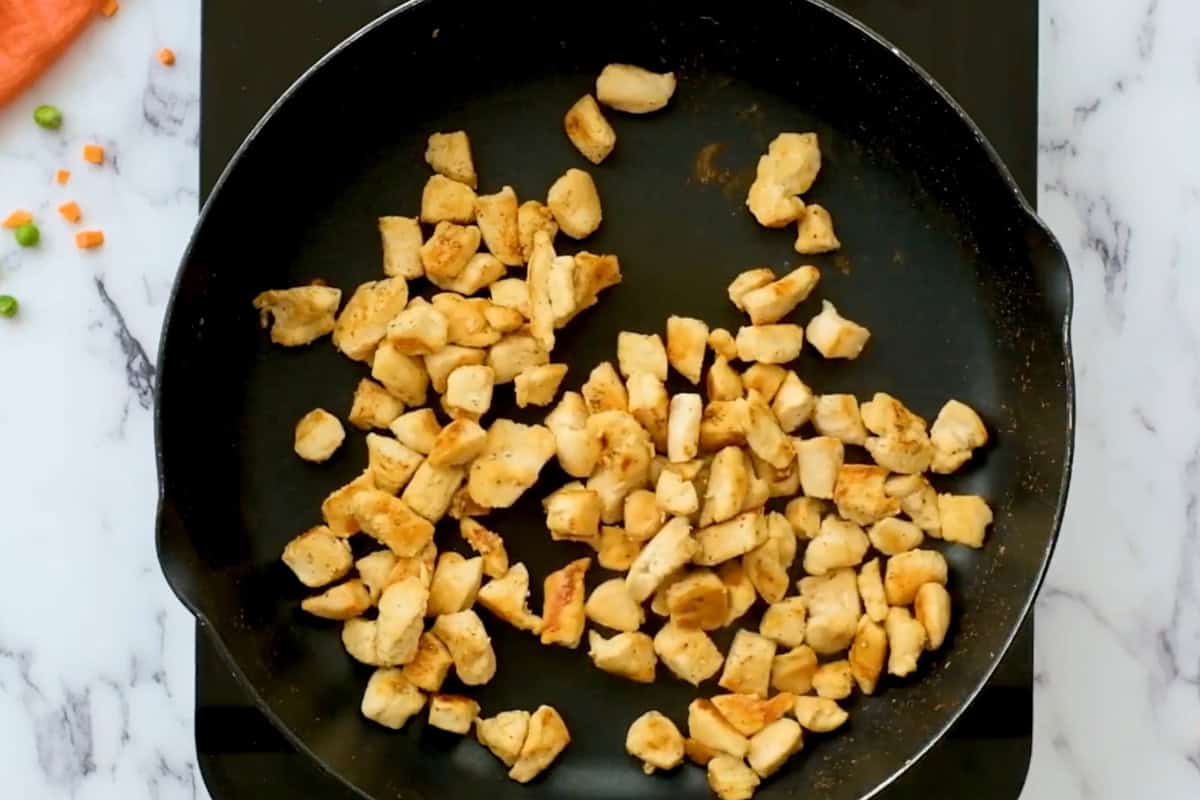 cooked cubed chicken in a pan.