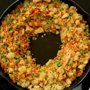 a well in the center of quinoa chicken fried rice.