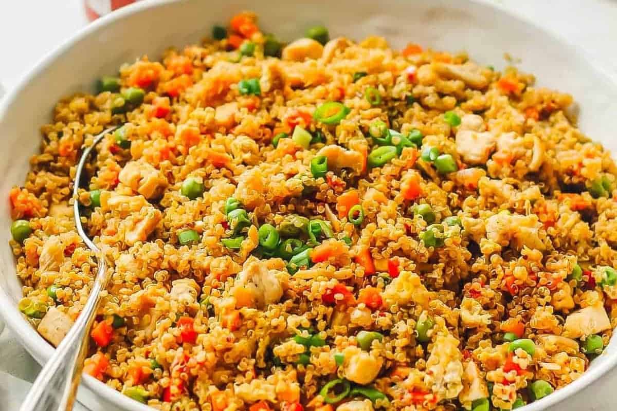 a large serving bowl filled with quinoa chicken fried rice.
