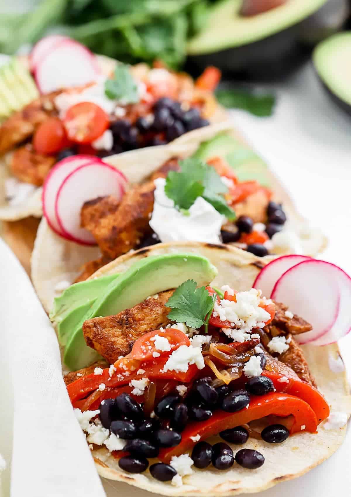 blackened chicken tacos with avocado and black beans