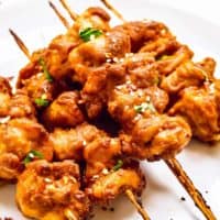 up close stacked chicken satay skewers