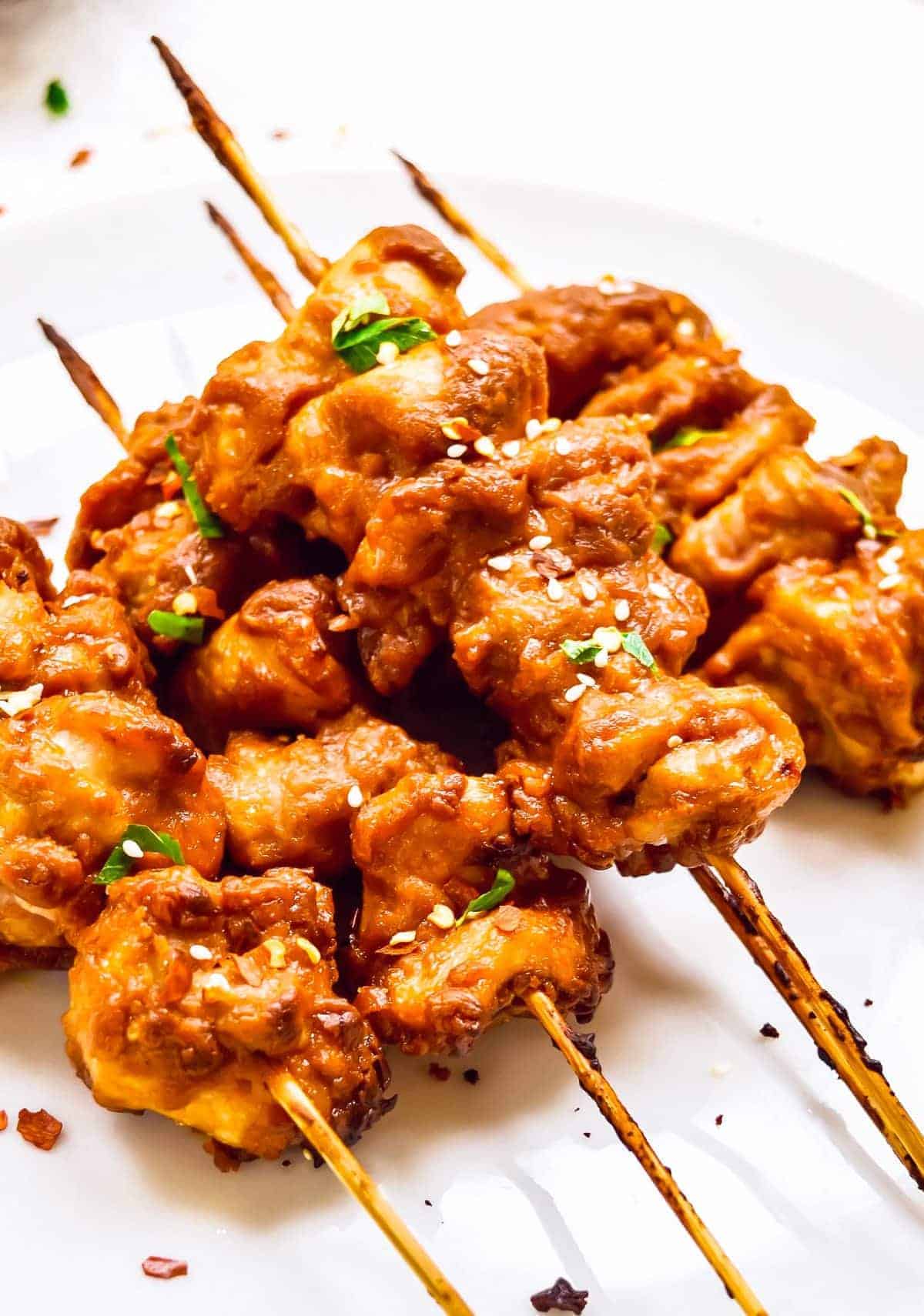 up close stacked chicken satay skewers