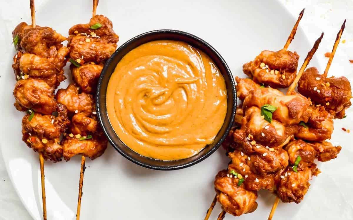 up close chicken skewers with satay peanut sauce