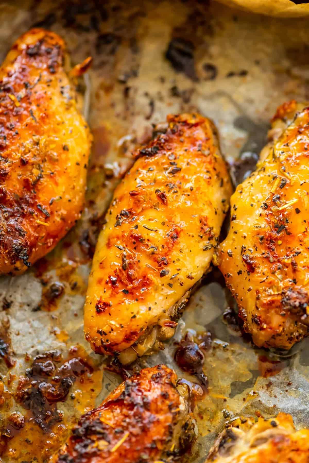 garlic herb baked chicken wings on baking sheet with parchment