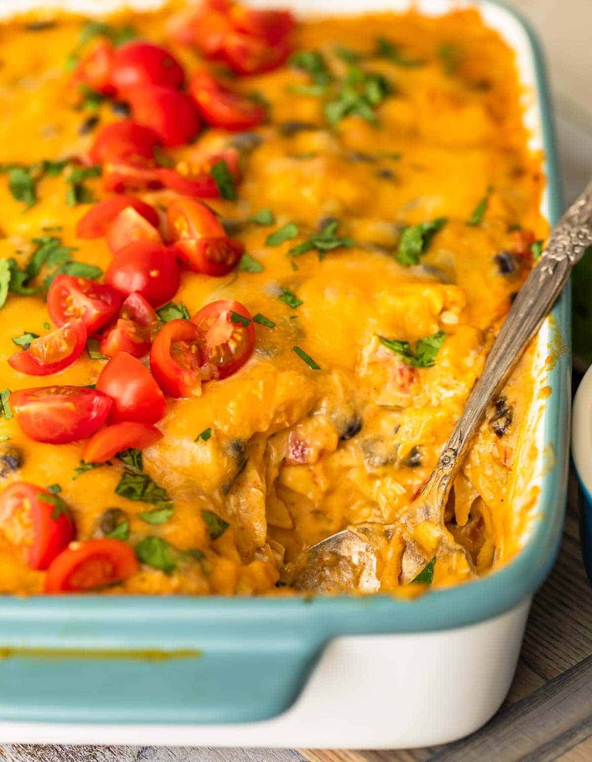 up close picture of green chile chicken casserole in a baking dish