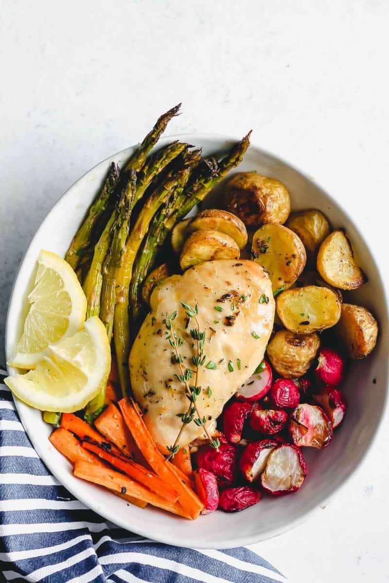 herb chicken served in a bowl with roasted vegetables