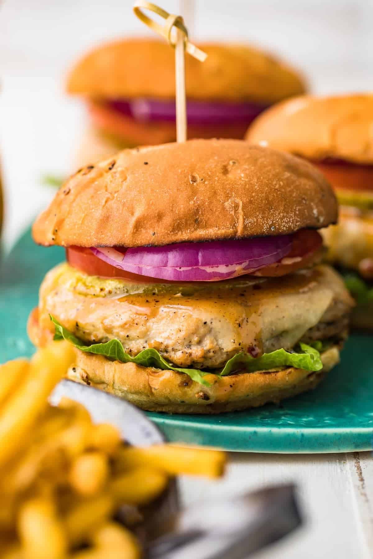 A juicy chicken burger served on a blue plate