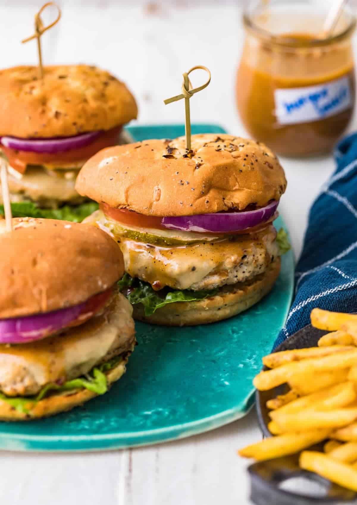 three juicy chicken burgers served with fries