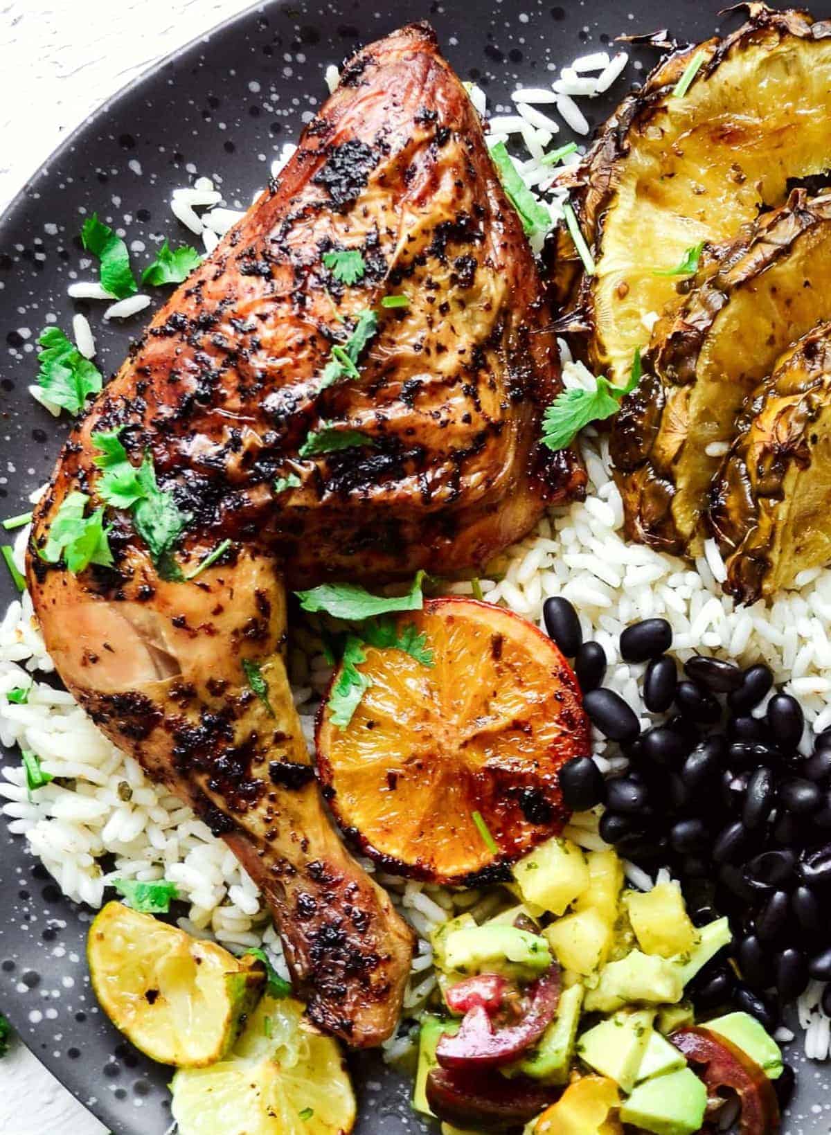 Close up of Cuban mojo chicken on a black plate