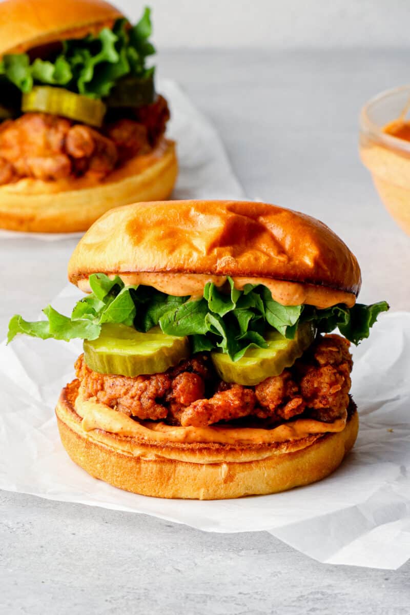 fried chicken sandwich with sauce and pickles