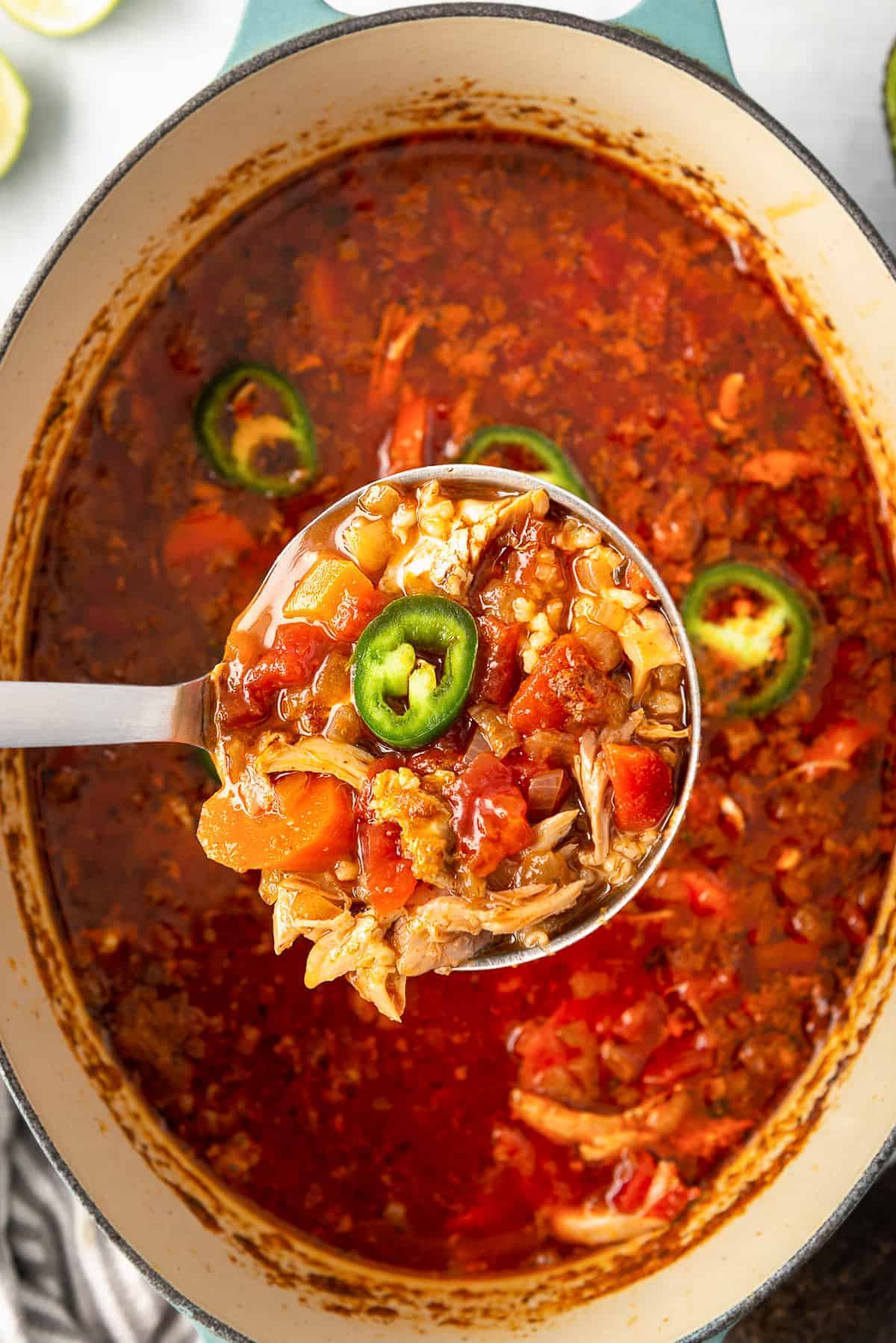 ladle lifting up spicy Mexican chicken soup