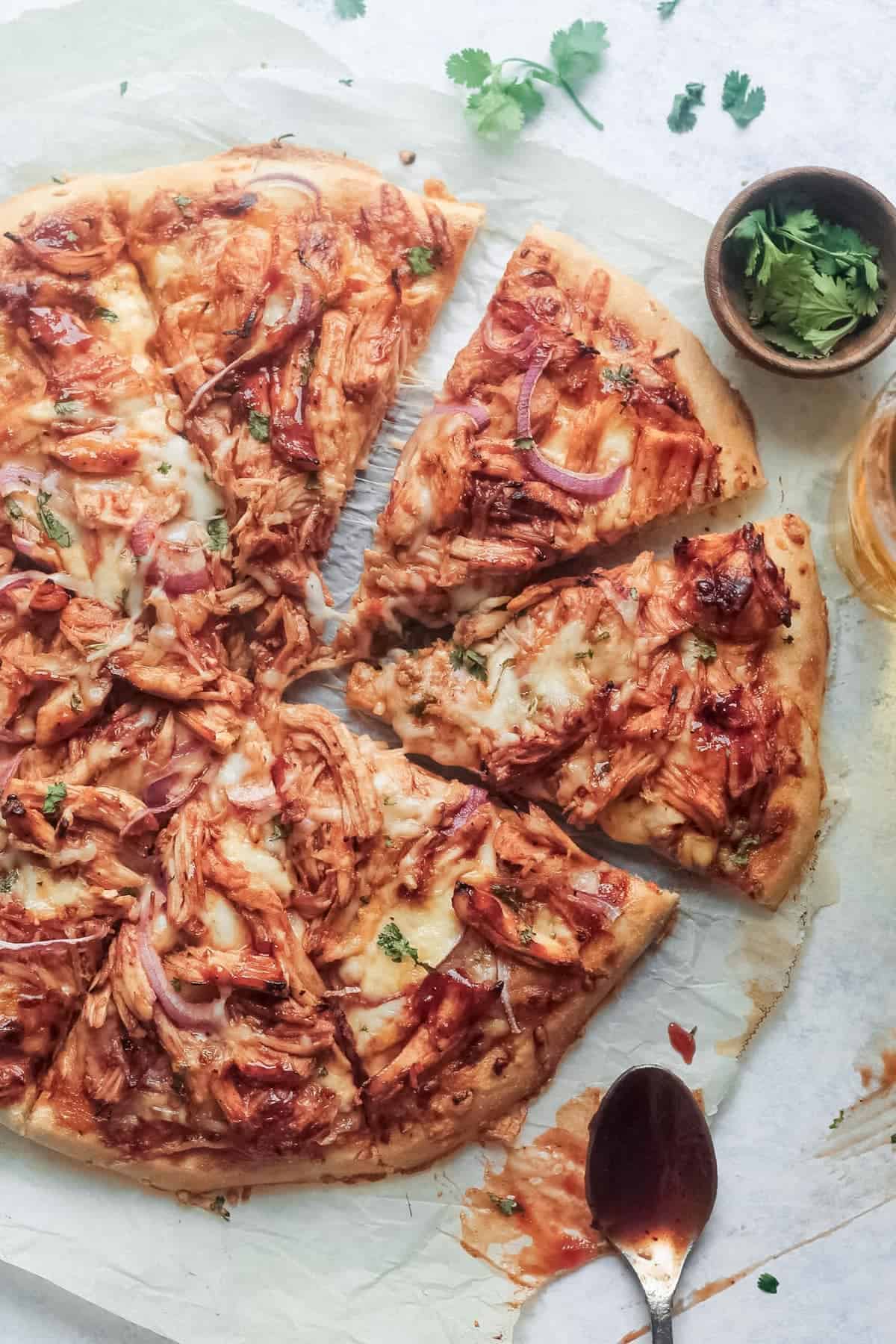 BBQ chicken pizza topped with fresh herbs