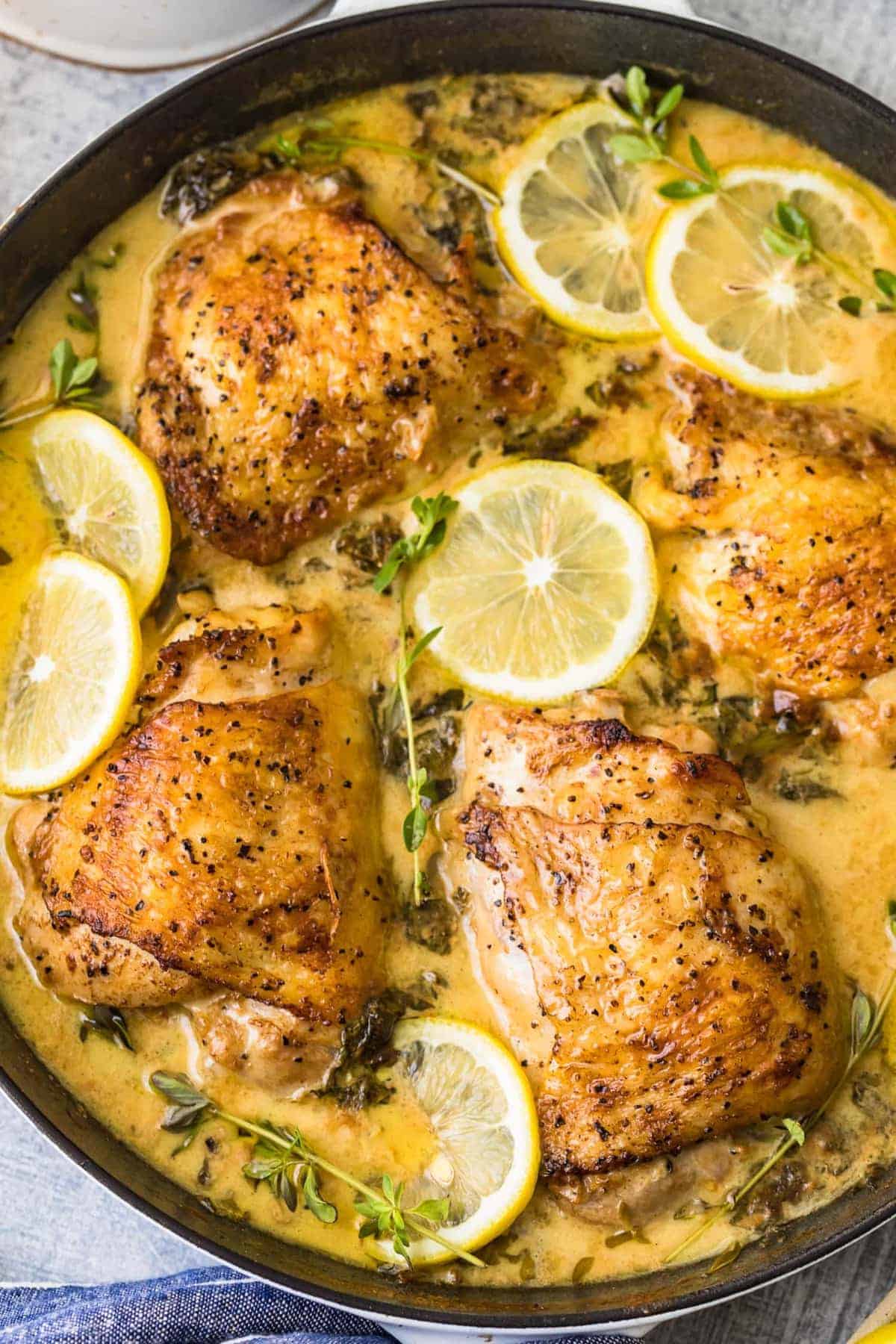 close up of lemon butter chicken thighs in a skillet