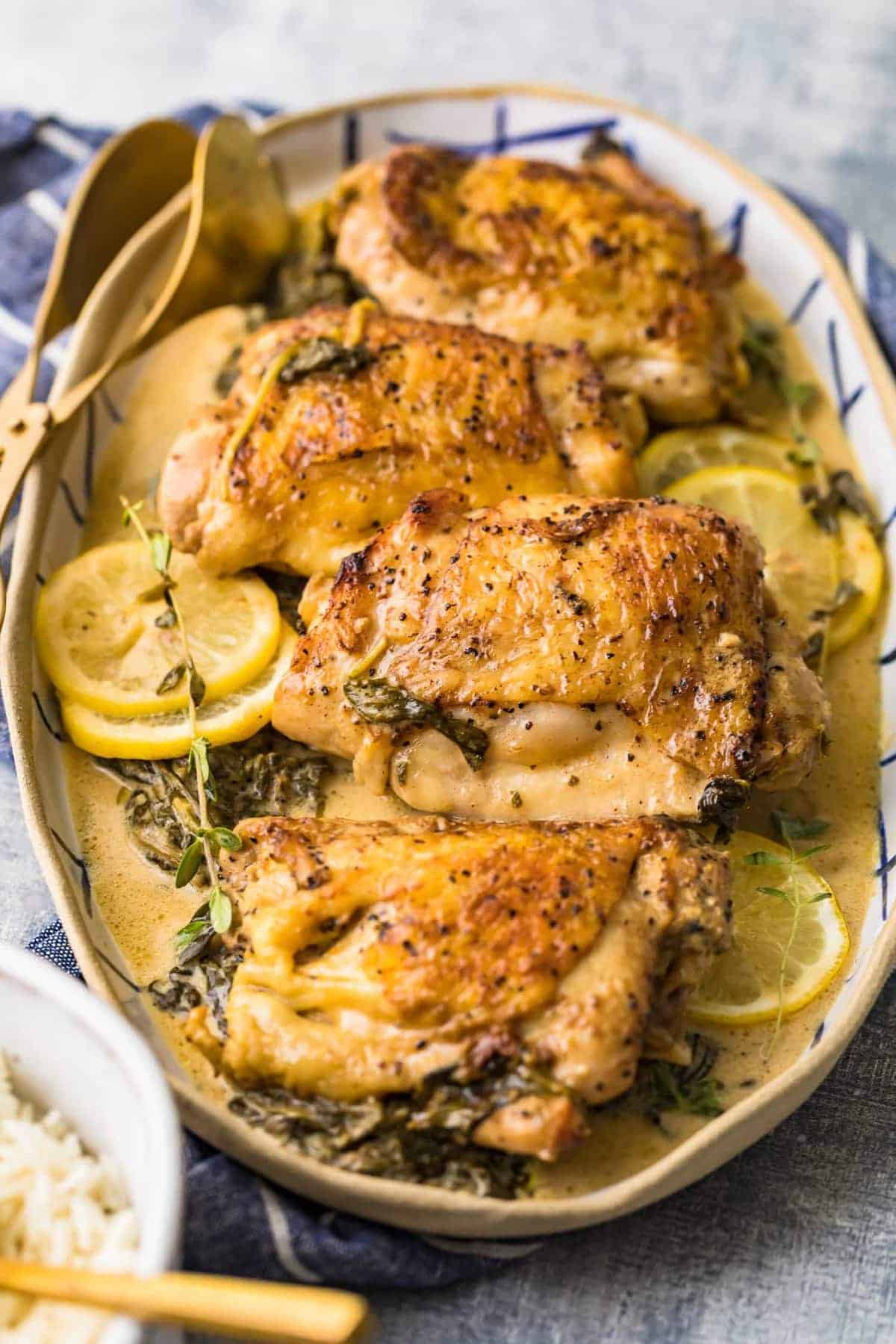 Lemon butter chicken thighs served on a large plate