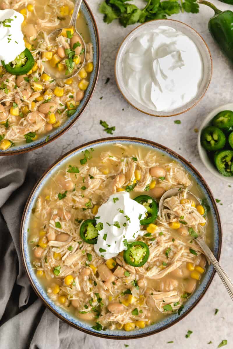 Slow cooker white chicken chili with sour cream and jalapenos.