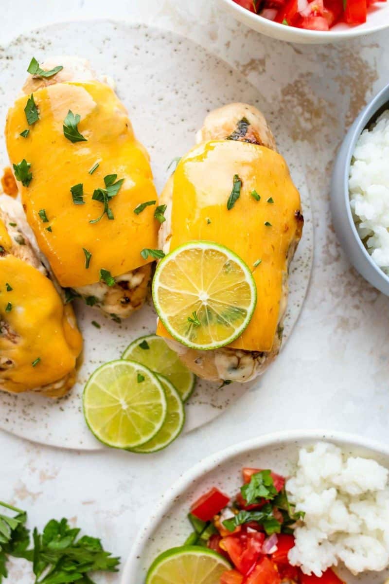 Fiesta lime chicken enchiladas paired with rice and lime wedges.