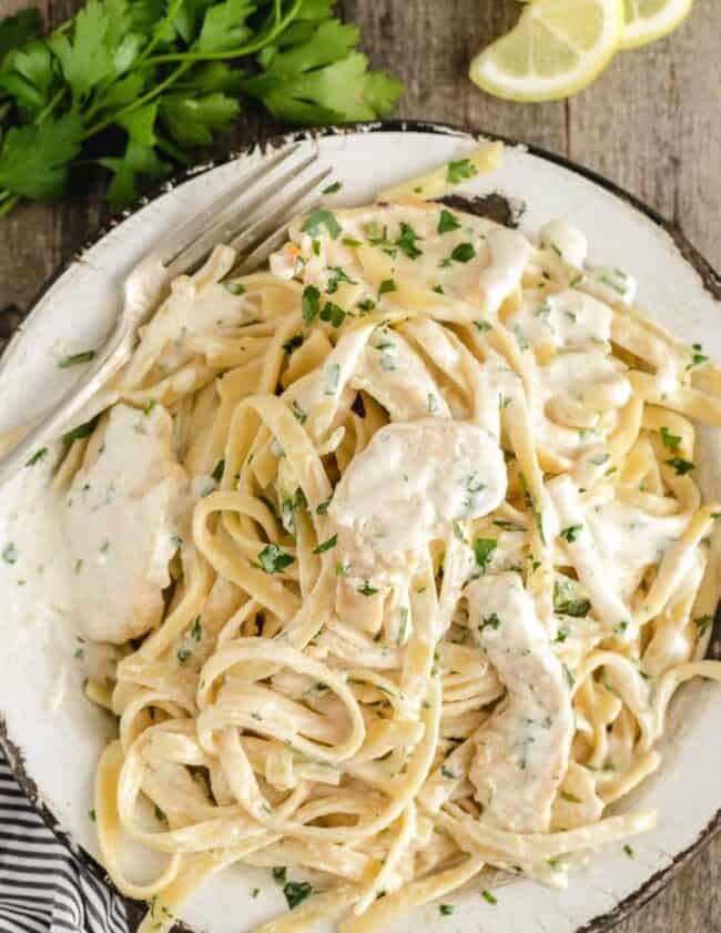 plated chicken alfredo with lots of white sauce