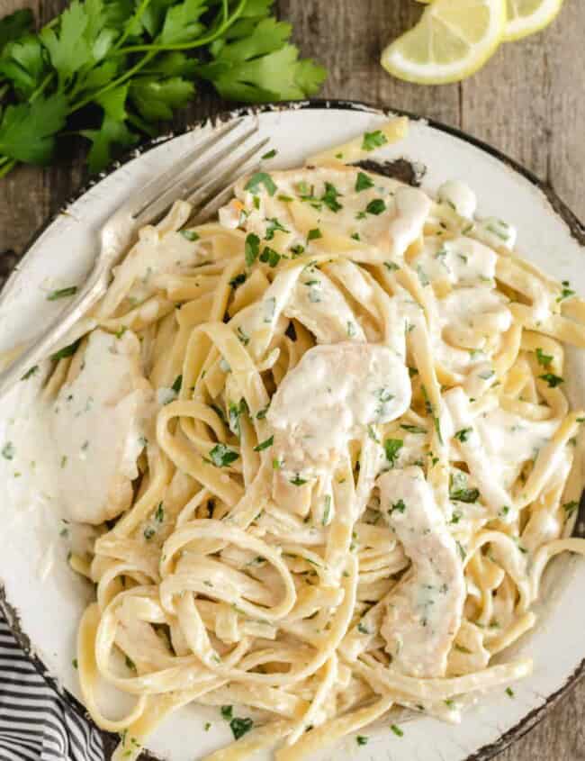 plated chicken alfredo with lots of white sauce