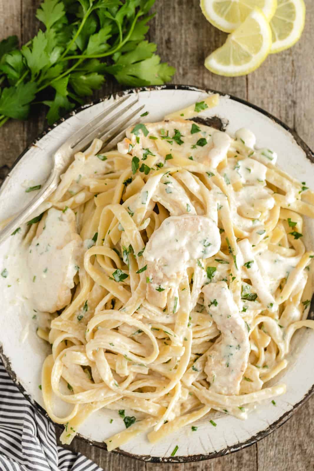 plated chicken alfredo with lots of white sauce