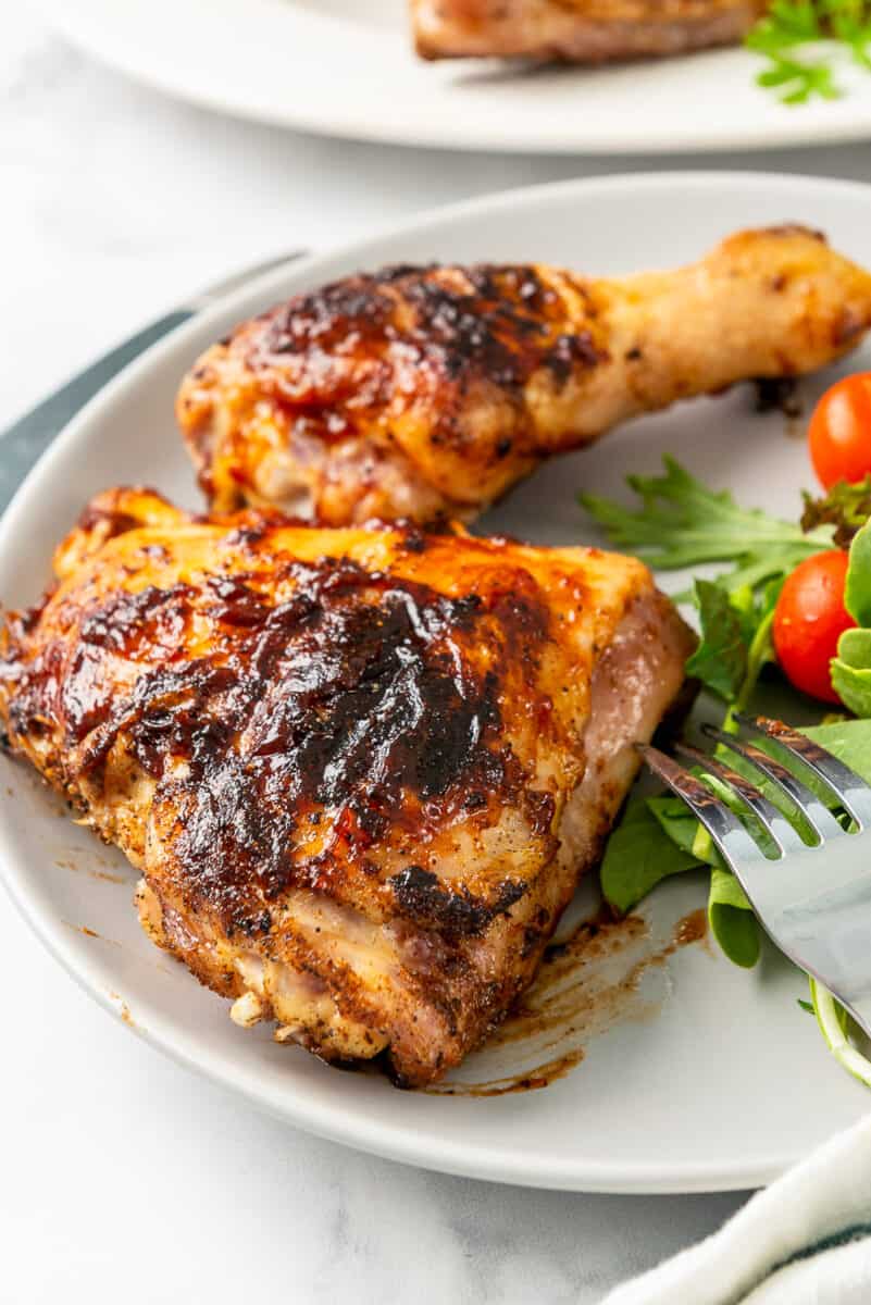 up close image of grilled bbq chicken thigh on plate