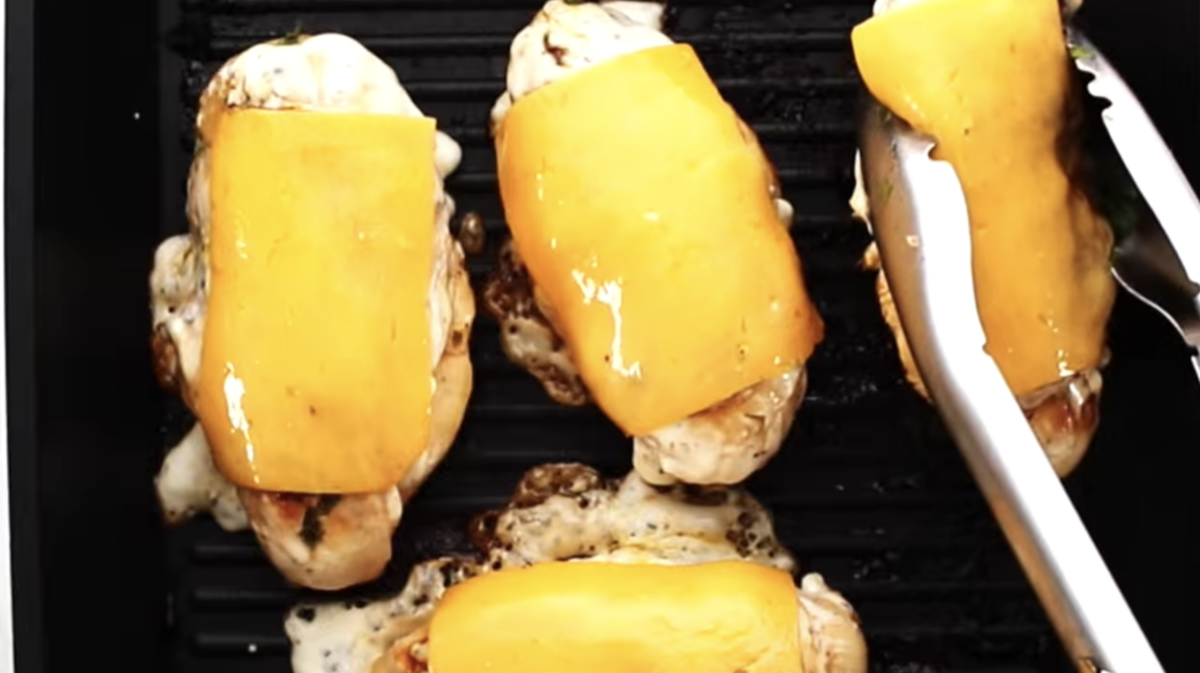 Cheese has melted atop each chicken breast.