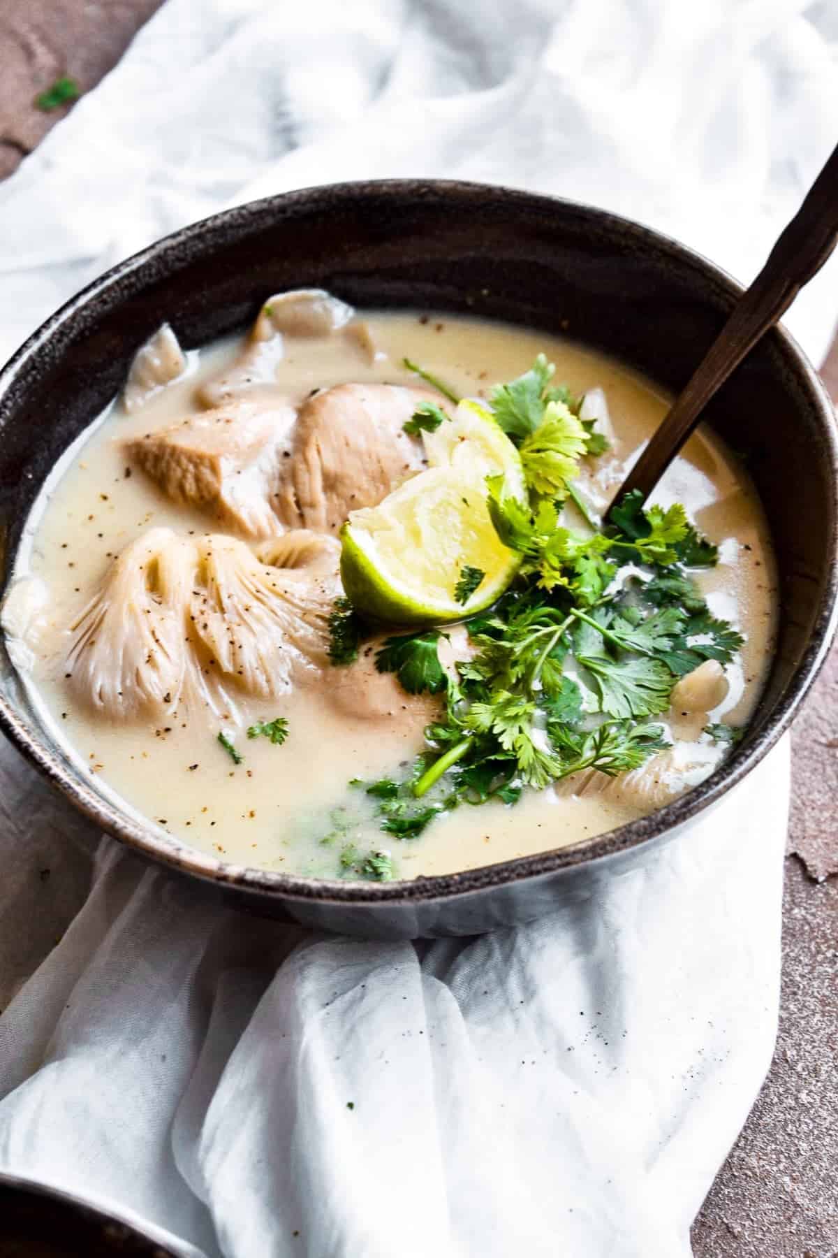 Chicken Coconut Soup served in a bowl with a spoon