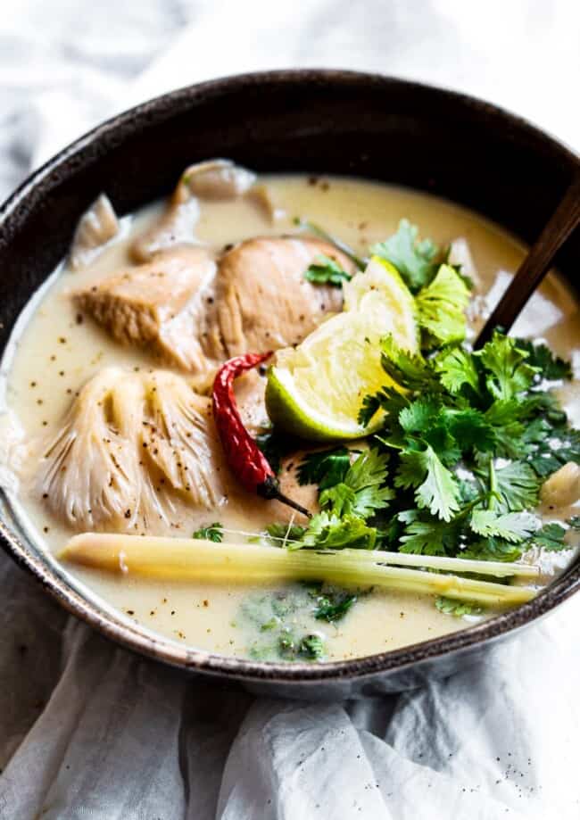 chicken coconut soup garnished with cilantro