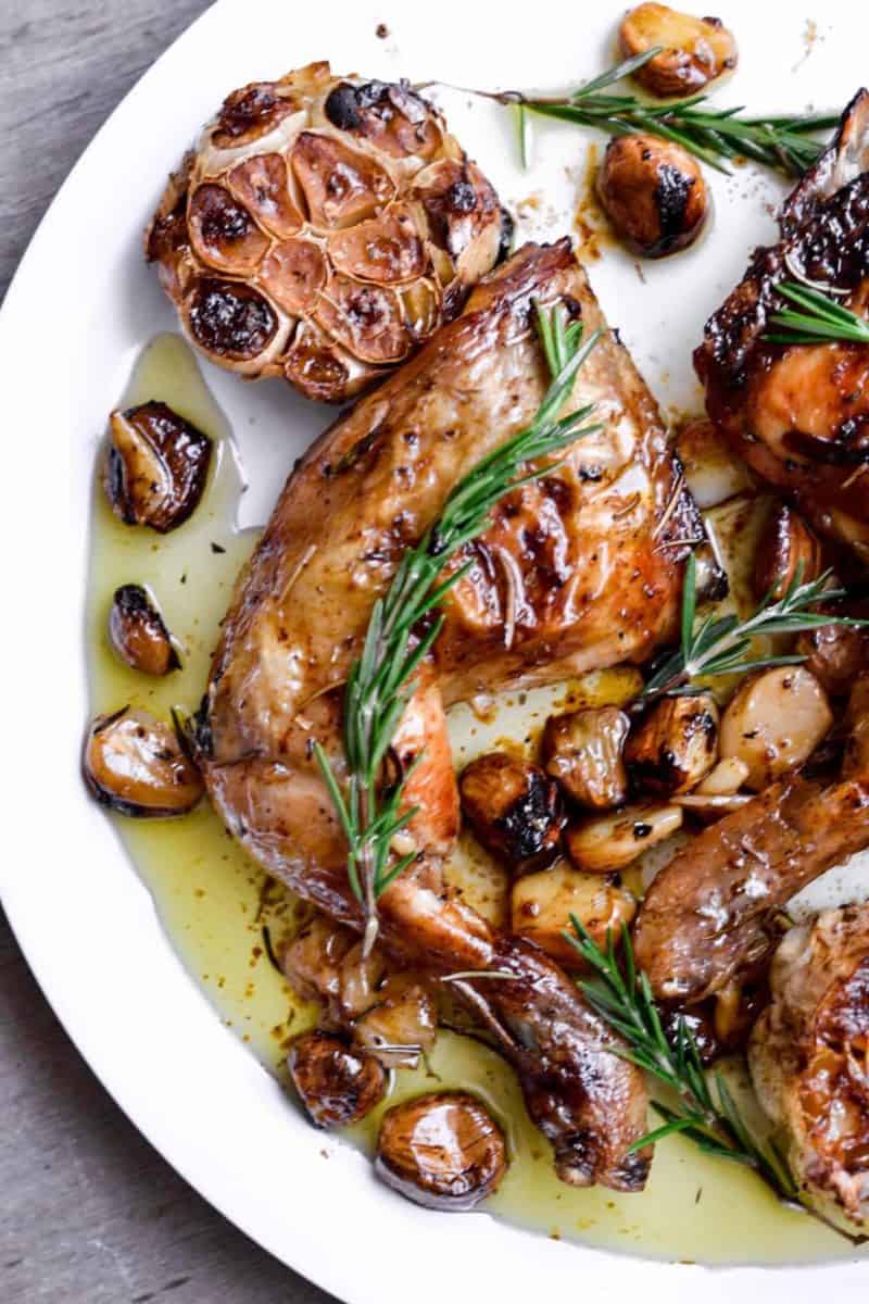 Roasted chicken with mushrooms and sprigs of rosemary, served with 40 cloves of garlic.