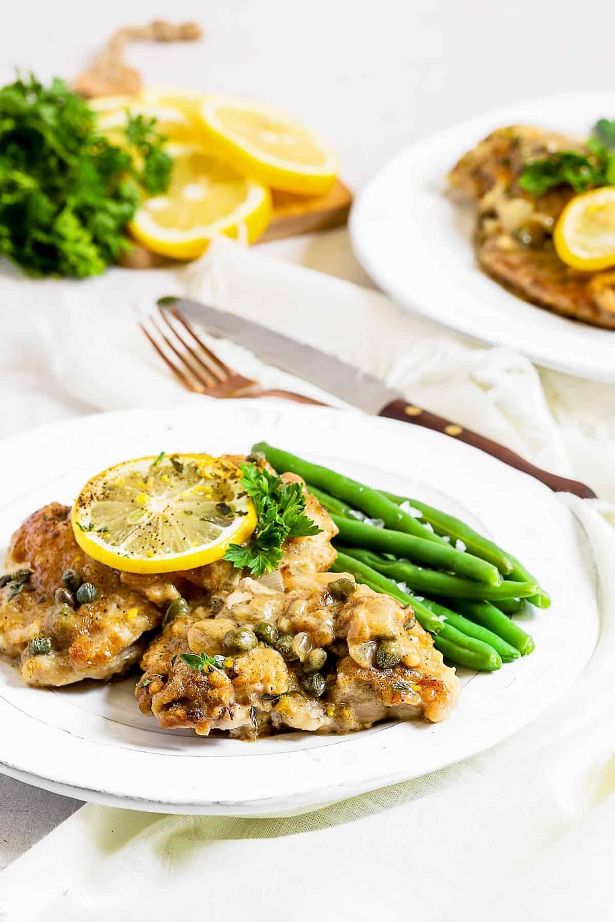 Creamy chicken piccata served on two white plates