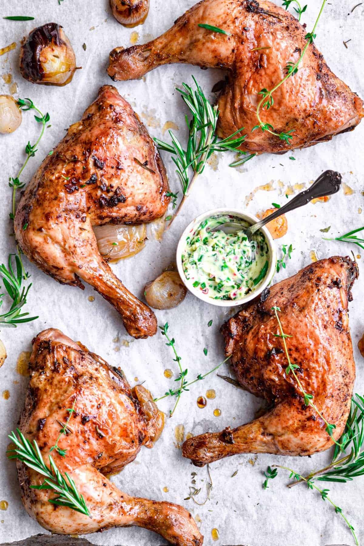 Roasted chicken legs served with herb butter