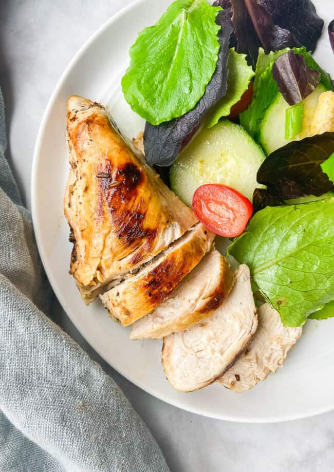 sous vide chicken breast with salad on plate