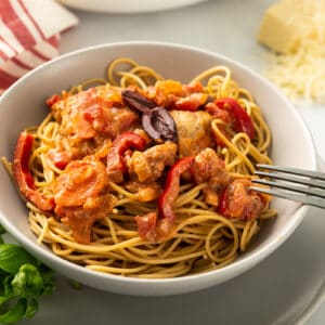 side shot of chicken cacciatore topped with olives