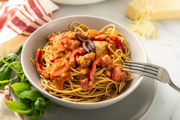 side shot of chicken cacciatore topped with olives