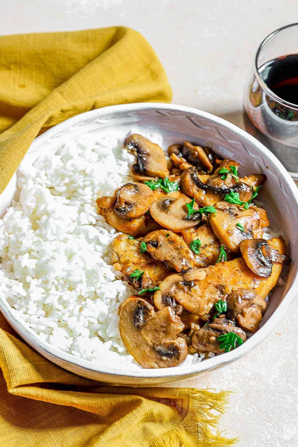 Chicken Marsala served with rice in a white bowl