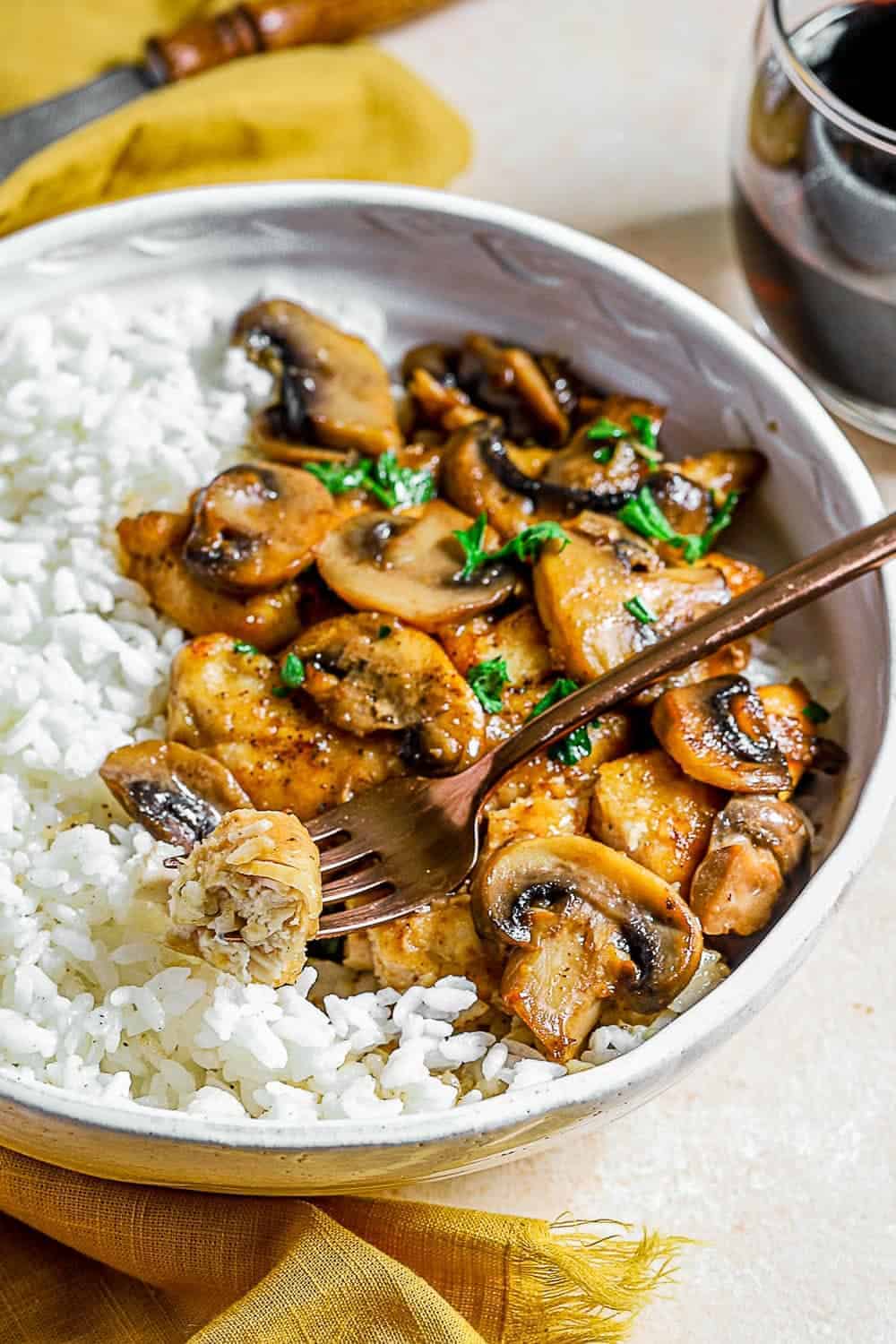 Chicken Marsala served in a bowl with a fork