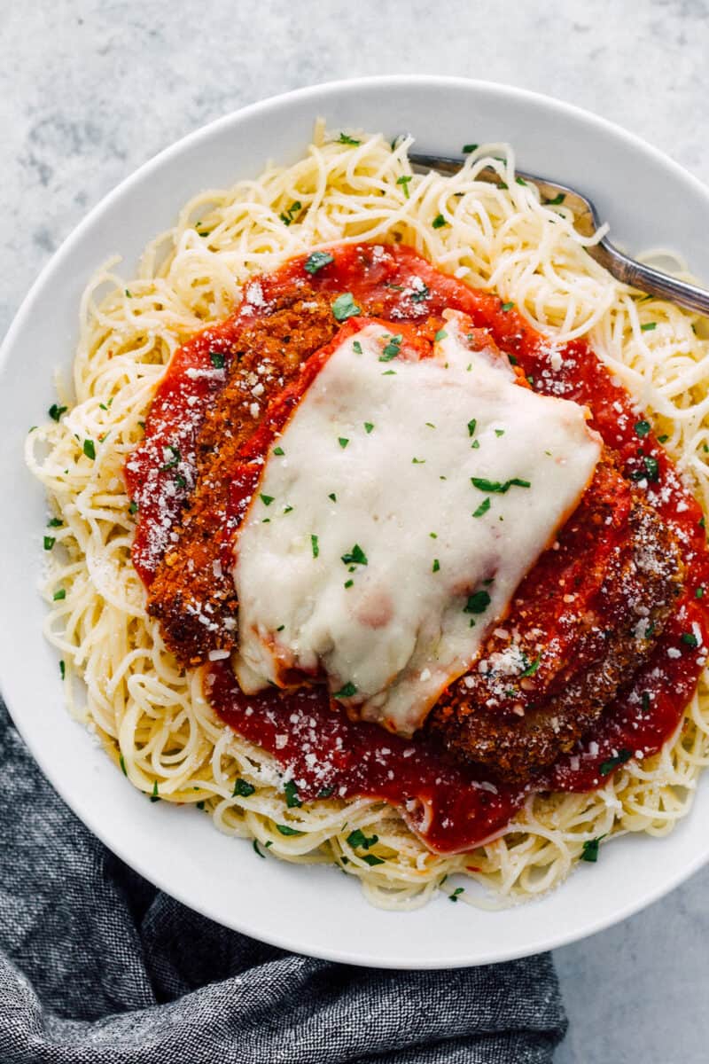 easy chicken parmesan over sauce and pasta